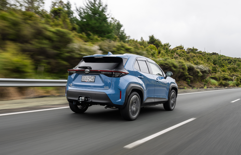 Rear view of a Toyota Yaris Cross driving on a highway