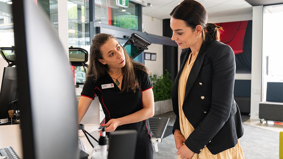 A Toyota team member speaking with a customer